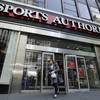A woman leaves a Sports Authority store in New York on Wednesday, March 2, 2016.