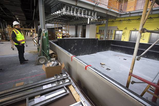Bryan O’Reilly, left, Topgolf Las Vegas partner, and Dominic Crespo, director of construction, speak by a third-level pool under construction during a tour of Topgolf Las Vegas at Koval Lane and Harmon Avenue on Monday, March 7, 2016. The pool will have a swim-up bar, they said.