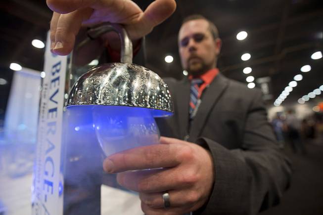 Matt Himes of Beverage Air frosts a glass using Rapid Chill Instant Glass Froster during the 2016 Nightclub & Bar convention at the Las Vegas Convention Center Tuesday, March 8, 2016.