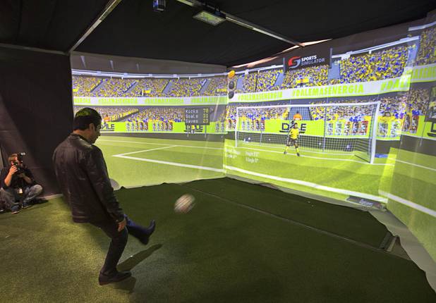 Faiz Sheet of La Jolla, Calif. takes a shot on goal at a Dale energy drink booth during the 2016 Nightclub & Bar convention at the Las Vegas Convention Center Tuesday, March 8, 2016.