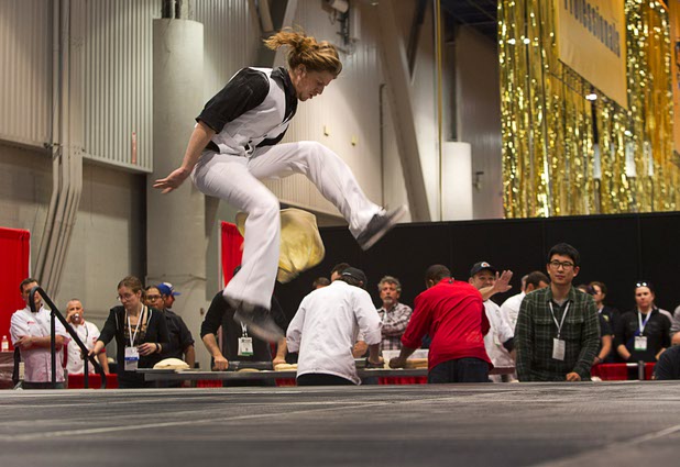 Collin Myers. of Fratelli Pizza in Flagstaff, Ariz.,  gives a disco-inspired performance during the World Pizza Games Freestyle Acrobatic Dough Tossing competition at the 2016 International Pizza Expo in the Las Vegas Convention Center Tuesday, March 8, 2016.