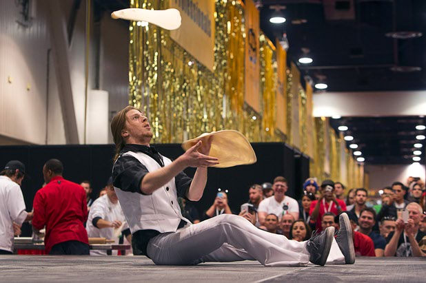 Collin Myers. of Fratelli Pizza in Flagstaff, Ariz.,  gives a disco-inspired performance during the World Pizza Games Freestyle Acrobatic Dough Tossing competition at the 2016 International Pizza Expo in the Las Vegas Convention Center Tuesday, March 8, 2016.