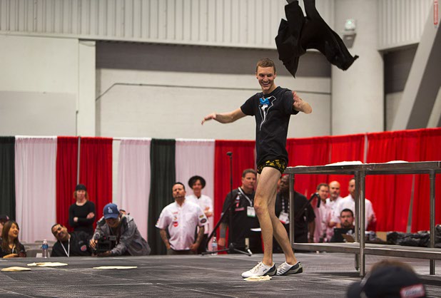 Nick Diesslin, of Randy's Premier Pizza in Minneapolis Minn., rips off his pants as he performs during the World Pizza Games Freestyle Acrobatic Dough Tossing competition at the 2016 International Pizza Expo in the Las Vegas Convention Center Tuesday, March 8, 2016.