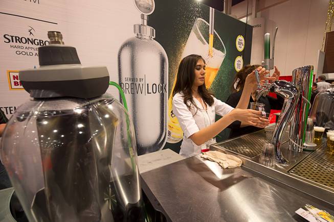 Nathalie Cabrera draws a beer using a BrewLock system during the 2016 International Pizza Expo at the Las Vegas Convention Center Tuesday, March 8, 2016. The BrewLock system delivers draught beer without adding carbonation and the keg is 100% recyclable, a representative said.