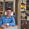 Jonathan Pluvinet owns Rosallie Le French Café. He laid the brick counter himself, and the lantern to his left was once his grandfather’s.