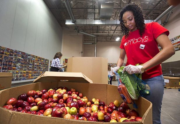 Macy's sales associate Ashley McGee bags produce for the Senior Share program at Three Squares north campus, 4220 N. Pecos Rd., Wednesday, March 16, 2016.