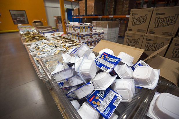 An assembly line is shown for the BackPack for Kids program at Three Squares north campus, 4220 N. Pecos Rd., Wednesday, March 16, 2016. The meal backpacks are sent home with children on Fridays to cover them with food for the weekend.