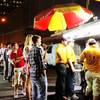 The line of customers at the Halal Guys in New York City stretches down the sidewalk at 1 a.m., June 21, 2014.