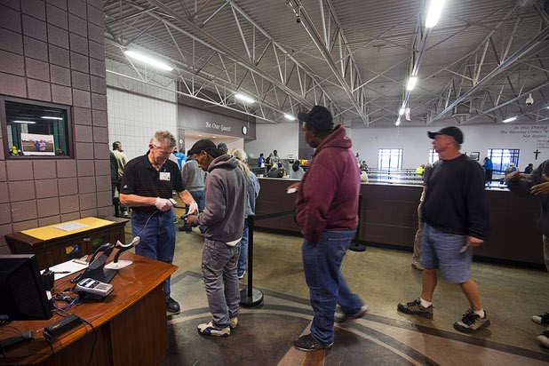 Men have their Clarity Card scanned as they line up for a meal at the St. Vincent Lied Dining Facility at Catholic Charities of Southern Nevada Tuesday, March 29, 2016. The Clarity Card system is a way of gathering data for grant-based charities.