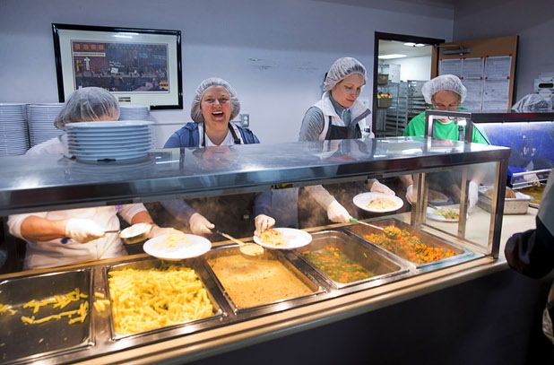Volunteers man a serving line in the St. Vincent Lied Dining Facility at Catholic Charities of Southern Nevada Tuesday, March 29, 2016. From left: Jeaneane McCandless, Suzanne Gabelick-Baerlocher, and Bill Koss. The kitchen has a small staff and relies heavily on volunteers, said executive chef Juan Penate.