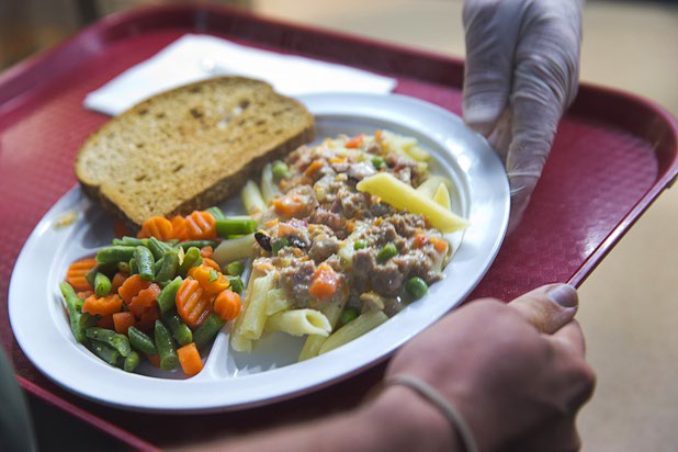 A man picks up a meal from the serving line in the St. Vincent Lied Dining Facility at Catholic Charities of Southern Nevada Tuesday, March 29, 2016. The charity will celebrate 75 years of service in Southern Nevada this April.