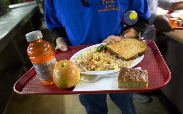 A man picks up a meal from the serving line in the St. Vincent Lied Dining Facility at Catholic Charities of Southern Nevada Tuesday, March 29, 2016. The charity will celebrate 75 years of service in Southern Nevada this April.