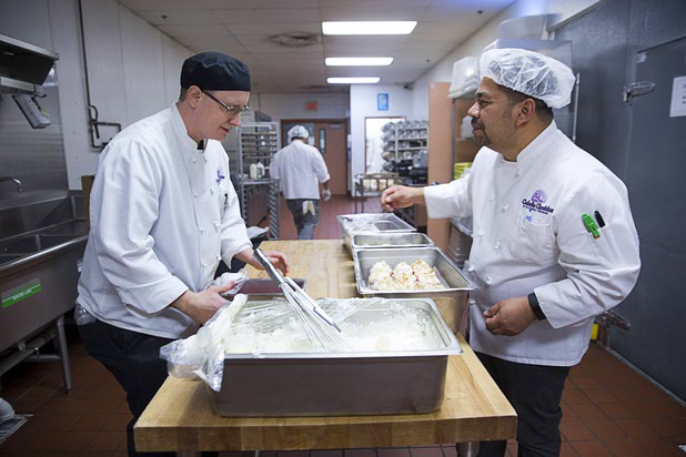 Chef Paul Munson, left, talks with executive chef Juan Penate in the Catholic Charities of Southern Nevada kitchen Tuesday, March 29, 2016. The charity will celebrate 75 years of service in Southern Nevada this April. The kitchen has a small staff and relies heavily on volunteers, Penate said.