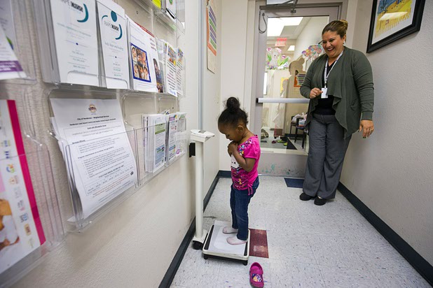 Women, Infants, and Children (WIC) clinic manager Caroline Mange weighs a 3-year-old at Catholic Charities of Southern Nevada Tuesday, March 29, 2016. The WIC clinic meets with 4,900 clients every month, said spokeswoman Leslie Carmine.