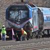 Amtrak investigators inspect a deadly train crash in Chester, Pa., on Sunday, April 3, 2016. The Amtrak train struck a piece of construction equipment just south of Philadelphia, causing a derailment.