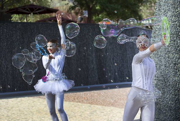 Bubble Girls Olga Lagunsad, left, and Tsvetelina Tabakova perform during the grand opening of The Park Monday, April 4, 2016. The new pocket park, lined with restaurants and seating for outdoor dining, runs from the Las Vegas Strip to the new T-Mobile Arena.
