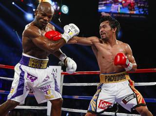 Manny Pacquiao, right, connects on Timothy Bradley Jr. during their welterweight fight at MGM Grand Garden Arena Saturday, April 9, 2016. STEVE MARCUS