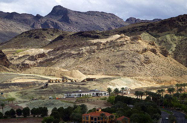 Earth-moving equipment is shown on a hillside at Lake Las Vegas on Sunday, April 10, 2016, in Henderson.
