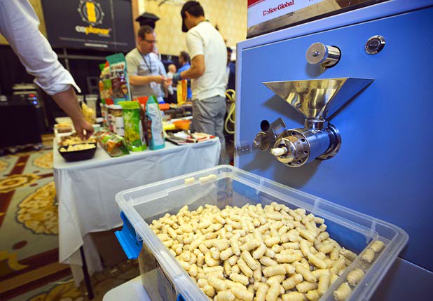 Kim's Bob Pop snacks are expelled from a machine during the CinemaCon trade show at Caesars Palace Wednesday, April 13, 2016. The healthy multigrain puff is "popped" without oil and comes in a variety of flavors. The snack is made with brown rice, quinoa, millet, flaxseed and corn.