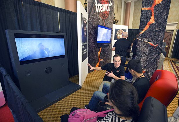 People try out Tremor FX theater seating during the CinemaCon trade show at Caesars Palace Tuesday, April 12, 2016. The chair works with the movie soundtrack to help viewer feel the vibrations of an explosion or the force of a punch. The sound waves are converted into vibrations in different areas of the seat depending on the pitch of the wave.
