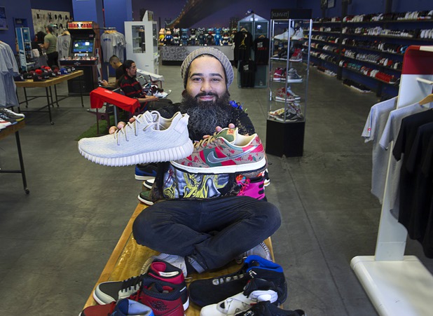 Owner Jaysse Lopez poses with some rare and pricey sneakers at Urban Necessities in the Boulevard mall Sunday, April 17, 2016. The Yeezy Oxford sneaker, left, is designed by Kanye West. At right is a rare Nike "Nightmare on Elm Street" (Freddy Krueger Dunk SB) prototype.