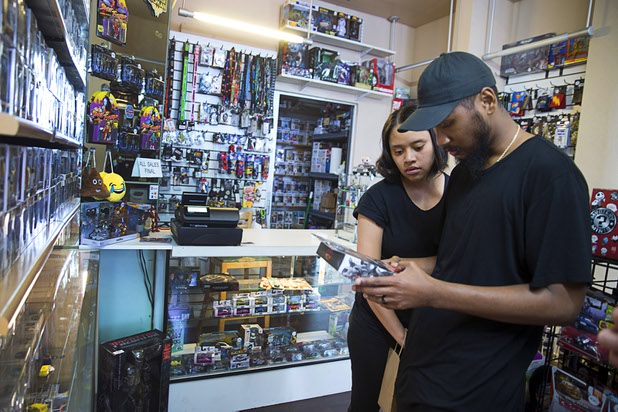 Shoppers Tony Webb and his wife Sherese Jenkins look over Marvel action figures at The Pop Shack in the Boulevard mall Sunday, April 17, 2016.