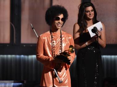 In this Feb. 8, 2015, file photo, Prince presents the award for album of the year at the 57th annual Grammy Awards in Los Angeles. Beyond dance parties and hit songs, Prince’s legacy included black activism. He said black lives matter before presenting a 2015 Grammy.