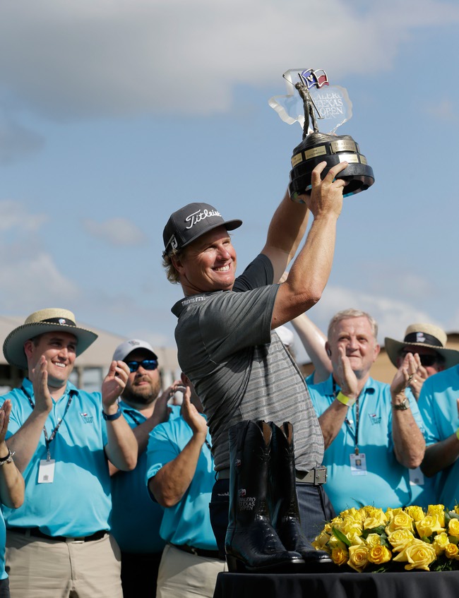 Charley Hoffman holds his trophy after winning the Texas Open golf tournament Sunday, April 24, 2016, in San Antonio.