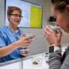 Registered nurse Jennifer Shepherd introduces Anna Cohen to new products Friday, April 22, 2016, at Essence Cannabis Dispensary. Shepherd helps customers find effective strains for pain relief. 