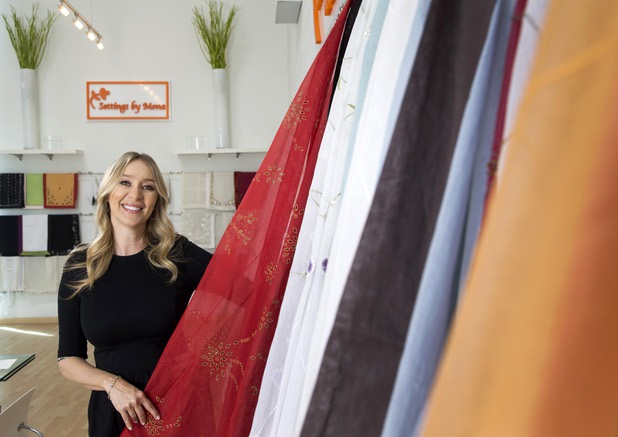 Mona Steck, owner of Settings by Mona, a luxury linen company that specializes in hand embroidered/tailored table and bed linens, poses in her showroom Wednesday, April 27, 2016.