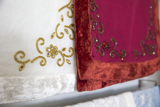 Custom beadwork is shown on linen at Settings by Mona, a luxury linen company that specializes in hand embroidered/tailored table and bed linens, Wednesday, April 27, 2016.