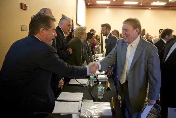UNLV President Len Jessup, left, shakes hands with Oakland Raiders owner Mark Davis during a meeting of the Southern Nevada Tourism Infrastructure Committee at UNLV Thursday, April 28, 2016.