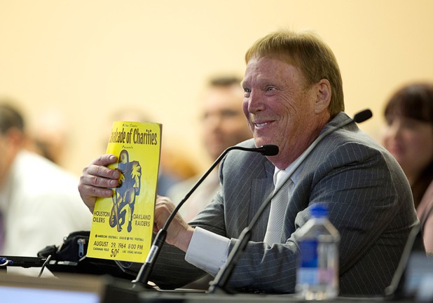 Oakland Raiders owner Mark Davis holds a program from a 1964 Raiders exhibition game in Las Vegas during a meeting of the Southern Nevada Tourism Infrastructure Committee at UNLV Thursday, April 28, 2016.