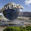 In this Thursday, Oct. 22, 2015, file photo, park guests relax and cool off with a water mist under the globe at Universal Studios City Walk in Orlando, Fla.