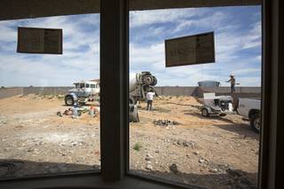 Landscapers build a block wall in the backyard of a home under construction at the Valley Heights by Elation Homes subdivision Wednesday, May 4, 2016, in Moapa Valley.