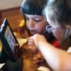Sisters play games on a tabletop electronic tablet at a Chili’s in New Jersey. Restaurants were late to the tech party, but some chains are using apps and tablets to improve food preparation, ordering and payment, and to entertain customers. 