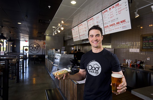 Adam Roll, general manager of Dog Haus poses with a "Sooo Cali" dog and a beer at the restaurant at 4480 S Paradise Rd. Monday, May 9, 2016. The California-based chain specializes in creative hot dogs, burgers, sausages & fries. The Las Vegas restaurant opened in March.