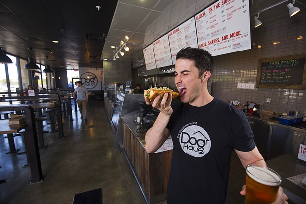 Adam Roll, general manager of Dog Haus, poses with a "Sooo Cali" dog and a beer at the restaurant at 4480 S Paradise Rd. Monday, May 9, 2016. The California-based chain specializes in creative hot dogs, burgers, sausages & fries. The Las Vegas restaurant opened in March.