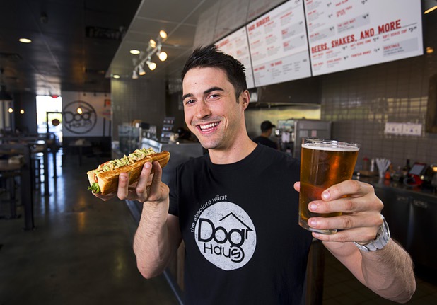 Adam Roll, general manager of Dog Haus, poses with a "Sooo Cali" dog and a beer at the restaurant at 4480 S Paradise Rd. Monday, May 9, 2016. The California-based chain specializes in creative hot dogs, burgers, sausages & fries. The Las Vegas restaurant opened in March.