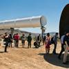 Guests and media check out several tubes after a Hyperloop One sled test Wednesday, May 11, 2016, in North Las Vegas.