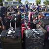 Baggage sits in the special events parking lot, Thursday, May 12, 2016, at Phoenix Sky Harbor International Airport. More than 3,000 checked bags missed their outbound flights in Phoenix because of a problem with a screening system at Sky Harbor International Airport.