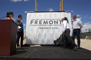 Nate Carlson (second left), vice president of development for the Wolff Company, Todd Kessler of Resort Gaming Group and Tim Wolff, executive vice president of development for the Wolff Company, unveil the name of the apartment complex during groundbreaking ceremony for Fremont9, a new apartment complex at East Fremont and Ninth streets, in downtown Las Vegas, Monday, May 16, 2016.