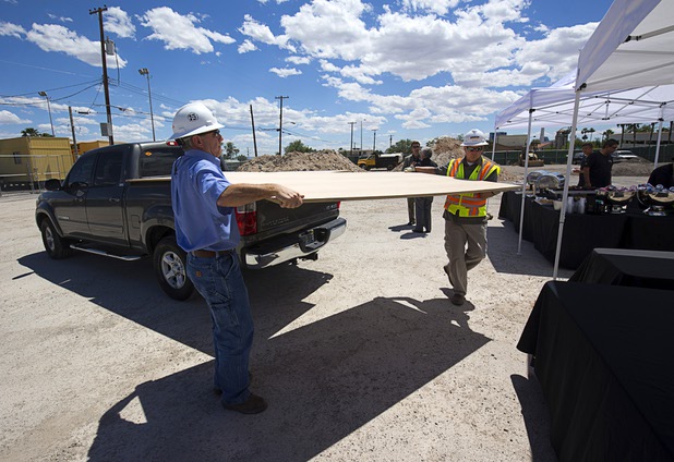Workers bring in panels during groundbreaking ceremony for Fremont9, a new apartment complex at East Fremont and Ninth streets, in downtown Las Vegas, Monday, May 16, 2016. Guest signed the panels, which will be used in the construction, during the event.