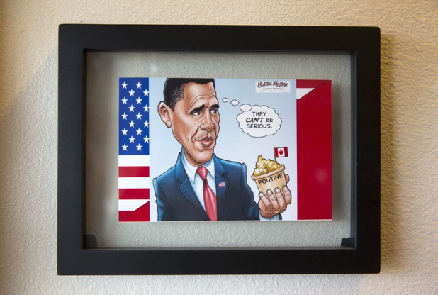 A cartoon showing President Barack Obama holding poutine is displayed at Salted Malted Bakery & Creamery, 6584 N. Decatur Blvd., Tuesday, May 17, 2016.  Poutine is a Canadian dish made with french fries and cheese curds topped with a light brown gravy.
