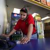 In this photo taken Thursday, May 24, 2012, Pizza Patron store manager Jose Gomez takes a phone order, in Dallas, Texas. 