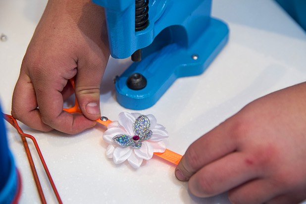 "Flip-flop genius" Christian Muniz assembles a customized flip flop at the Fashion Show mall kiosk location Monday, May 23, 2016. The company allows you to decorate your flip-flops, then watch a flip-flop genius put it together in front of you.