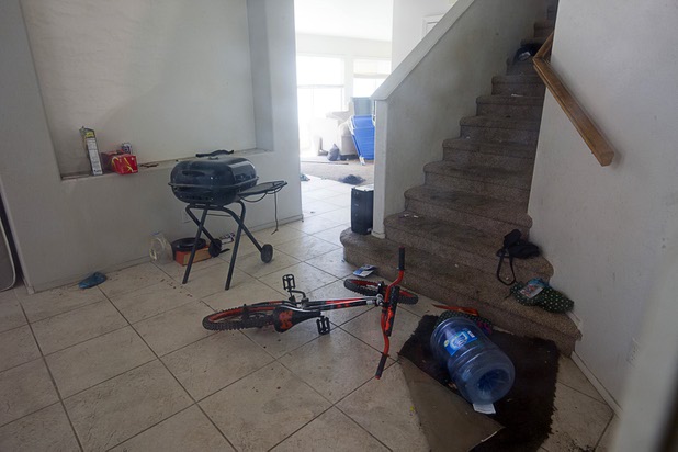 A look through a window into a home that had been occupied by squatters in North Las Vegas Wednesday, May 18, 2016.