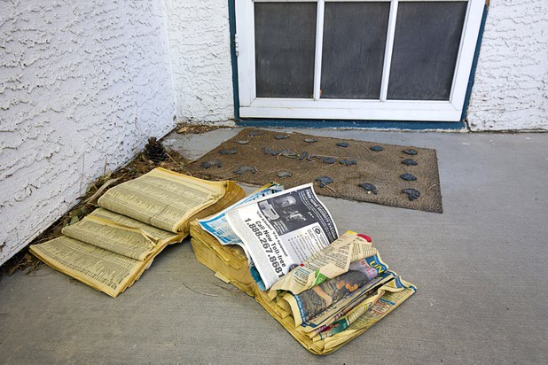 Old telephone directories are shown at a home that had been occupied by squatters in North Las Vegas Wednesday, May 18, 2016.