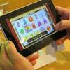 In this April 15, 2015, file photo, an employee at Resorts Casino Hotel tries a touch-screen tablet device in the Atlantic City, N.J. casino's new Internet gambling lounge. Internet gambling has tremendous growth potential in the United States as ever-greater percentages of the public use smartphones, participants in a major gambling conference said Wednesday, May 25, 2016. 
