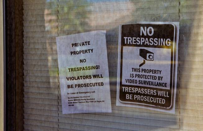 Signs such as these mark most of the windows at the location of an abandoned house at 5464 Sierra Brook Court on Thursday, May 26, 2016. Neighbors say the home had been occupied by several sets of squatters before Metro Police raided it in May.